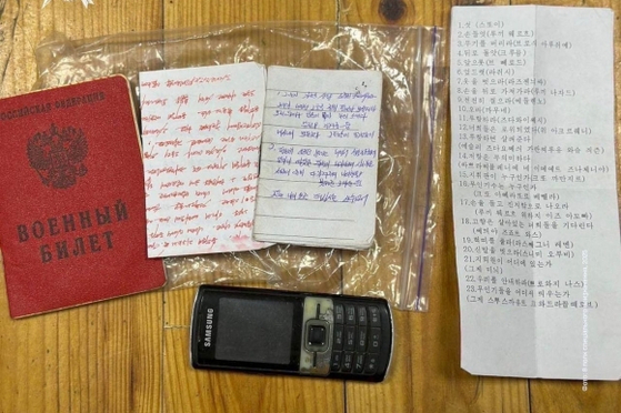 A photo released by the Ukrainian Special Operations Forces on Facebook on Jan. 28 shows the seized belongings of a fallen North Korean soldier. An older 2G Samsung mobile phone can be seen at the bottom. [SCREEN CAPTURE]