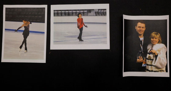 Photographs of athletes Jinna Han, left, and Spencer Lane, center, and coaches Vadim Naumov and Evgenia Shishkova, all of whom died in the crash of American Eagle flight 5342 in Washington, are displayed at the Skating Club of Boston in Norwood, Massachusetts on Jan. 30.  [REUTERS/YONHAP]