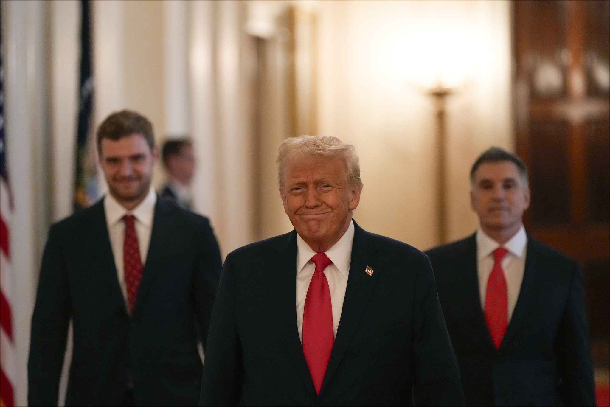 President Donald Trump arrives with Aleksander Barrow, left, and owner Vincent Viola to speak during a ceremony with the Florida Panthers NHL hockey team to celebrate their 2024 Stanley Cup victory in the East Room of the the White House, Monday, Feb. 3, in Washington. [AP]