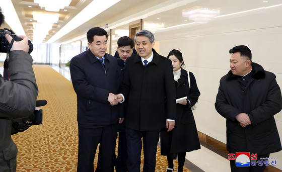 North Korean Sports Minister Kim Il-guk, left, chief of the North Korean delegation to the Feb. 7-14 Asian Winter Games in Harbin, northeastern China, departs Pyongyang for China at an international airport in the North Korean capital on Feb. 5, 2025, in this photo released by the North's official Korean Central News Agency the next day. [YONHAP]