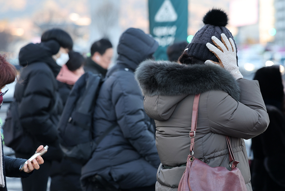 People wait to cross the road in Jongno District, central Seoul, amid the cold weather on Feb. 04. [NEWS1] 