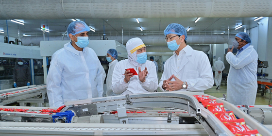 Lotte Wellfood co-CEO Paul Yi, right, examines Lotte India's production lines for Choco Pie at the firm's factory in Haryana, India. [LOTTE WELLFOOD]