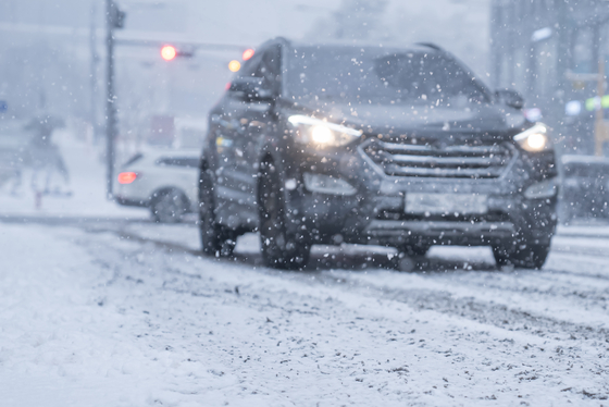 An image of a car driving on a snowy day [GETTY IMAGES BANK]