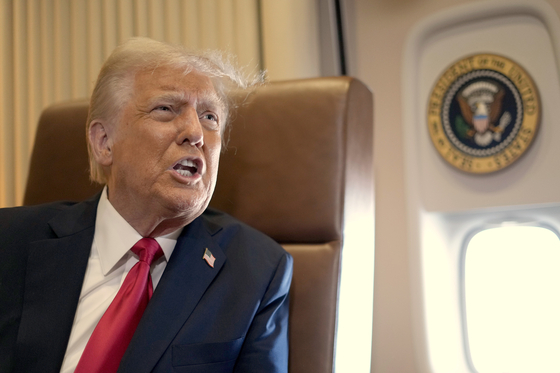 President Donald Trump speaks to reporters aboard Air Force One on Feb. 9. [AP/YONHAP]