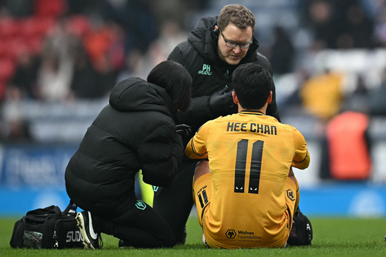 Wolverhampton Wanderers forward Hwang Hee-chan receives medical treatment during the FA Cup match against Blackburn Rovers at Ewood Park in England on Feb. 9. [AFP/YONHAP] 