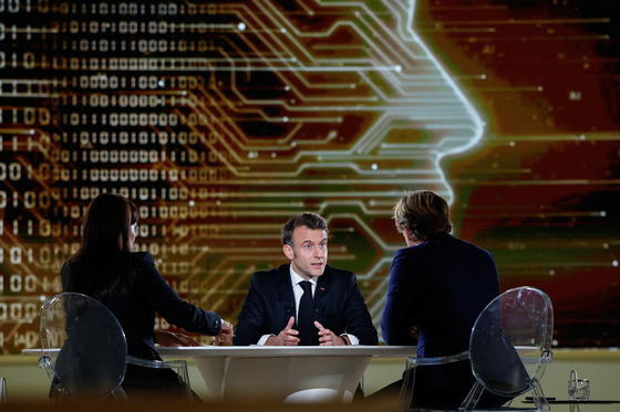 French President Emmanuel Macron attends an interview with French Journalist Laurent Delahousse and Indian Journalist Palki Sharma Upadhyay, on national television, ahead of the Artificial Intelligence Action Summit at the Grand Palais, in Paris, France, February 9. [REUTERS]