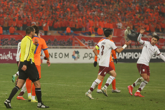 Gwangju FC, in white, celebrate during the 2024-25 AFC Champions League Elite match against Shandong Taishan at Jinan Olympic Sports Center in Jinan, China on Feb. 11. [GWANGJU FC]