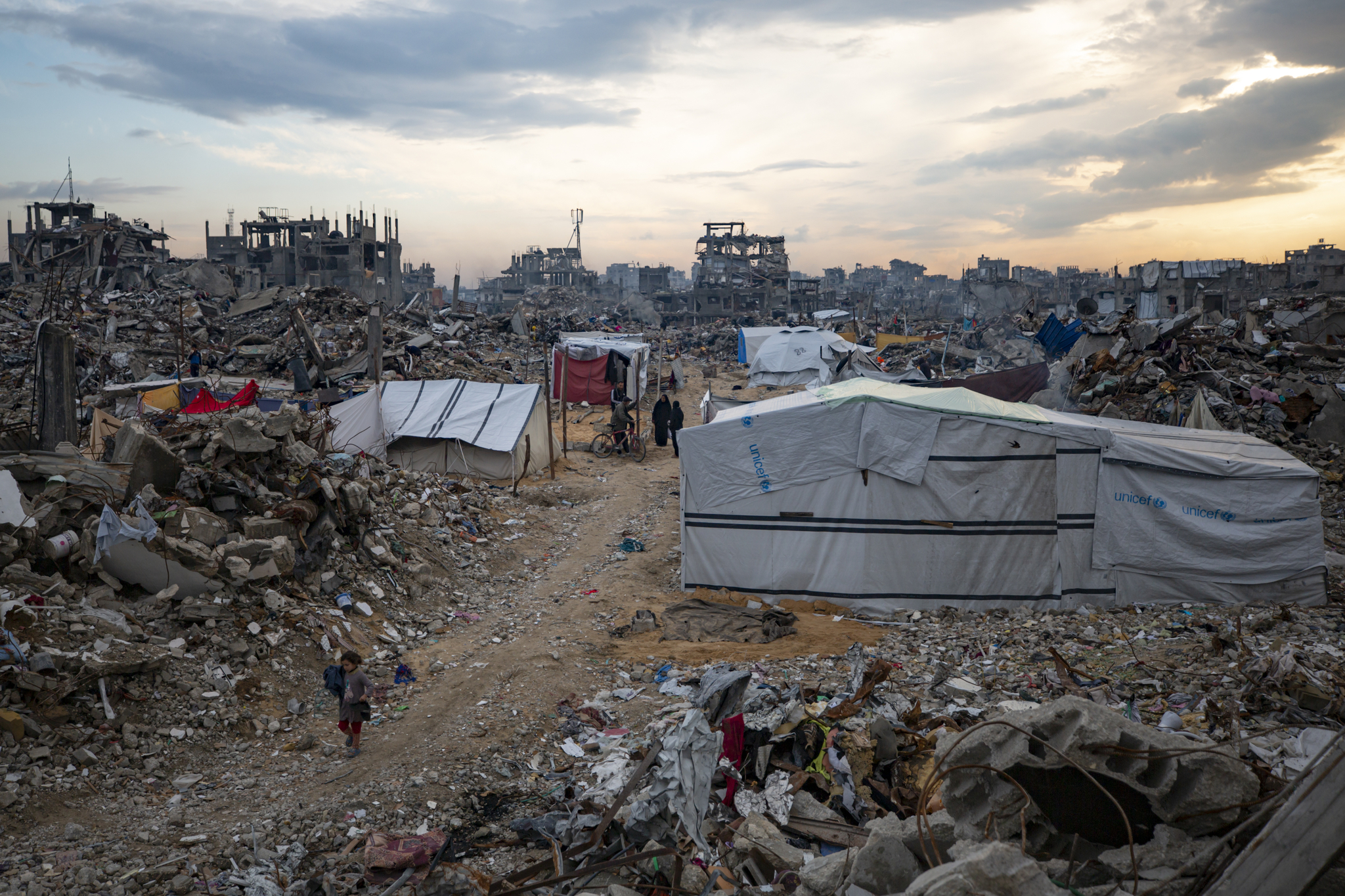 Palestinians walk in the destruction caused by the Israeli air and ground offensive in Jabaliya, Gaza Strip, on Feb. 11. [AP] 