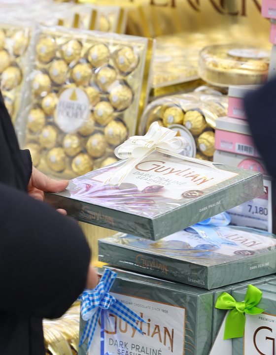 A shopper looks at chocolate on display at a store in Seoul on Feb. 13, the day before Valentine's Day. [YONHAP]