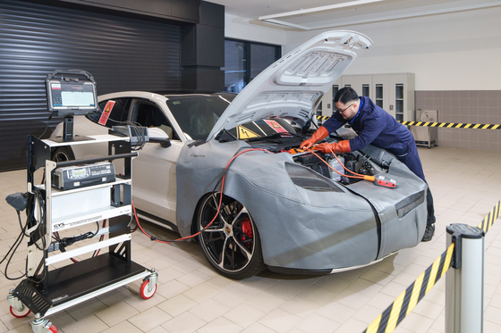 A Porsche staff repairs a car at its new service center in Seongsu-dong, eastern Seoul [PORSCHE KOREA]