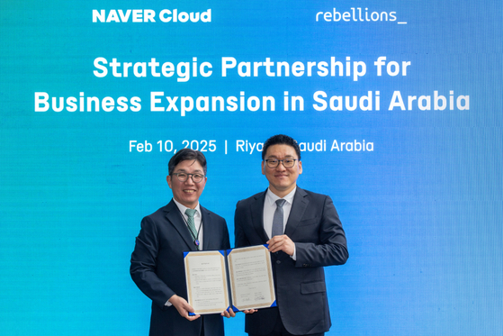Naver Cloud CEO Kim Yu-won, left, and Rebellions founder and CEO Park Sung-hyun pose for a photo after signing a strategic partnership for business expansion in Saudi Arabia on Feb. 10 in Riyadh, Saudi Arabia. [NAVER CLOUD]
