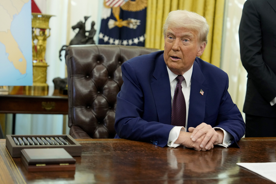 President Donald Trump speaks to reporters after signing an executive order in the Oval Office of the White House on Feb. 13, 2025, in Washington. [AP]