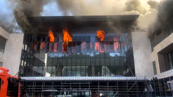 Smoke billows from a construction site for a luxury hotel in Busan on Feb. 14. [BUSAN METROPOLITAN POLICE] 