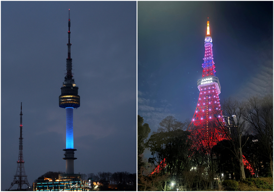 N Seoul Tower in Seoul, left, and Tokyo Tower in Japan's capital, displaying blue and red, respectively on Feb. 15, showing colors symbolizing Korea and Japan's national flags [YONHAP] 