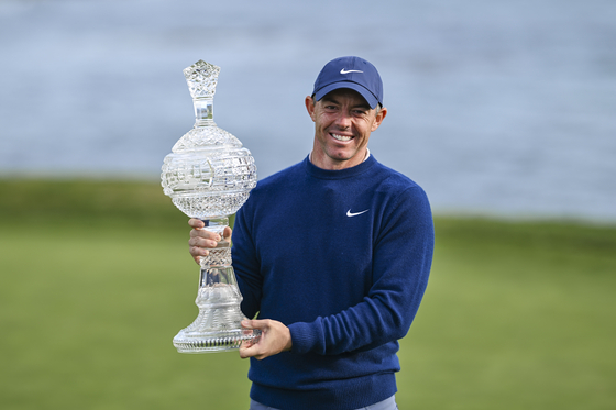 Rory McIlroy smiles with the tournament trophy following his two stroke victory in the final round of the AT&T Pebble Beach Pro-Am at Pebble Beach Golf Links on Feb. 2 in Pebble Beach, California. [GETTY IMAGES]