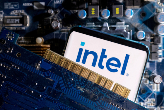 A smartphone with a Intel logo displayed is placed on a computer motherboard in this illustration from March 6, 2023. [REUTERS/YONHAP]