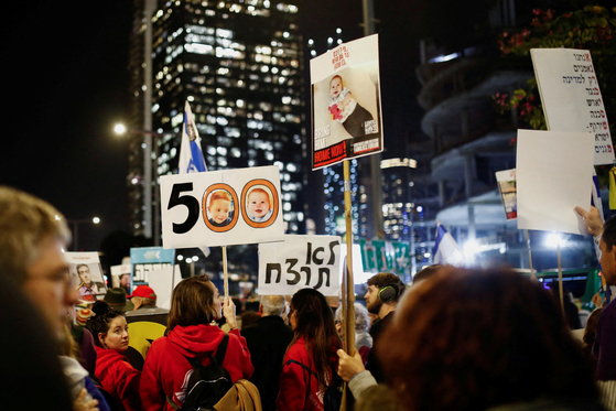 A person displays a sign that reads ″You shall not kill″ as family and supporters of hostages protest to mark the 500 days since Oct. 7, 2023, when Hamas attacked Israel and took hostages, in Tel Aviv, Israel, on Feb. 17. [REUTERS/YONHAP]