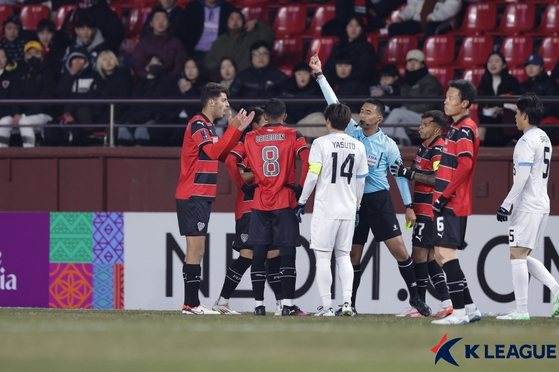 Pohang Steelers defender Jonathan Aspropotamitis, far left, reacts to the referee's call to send him off during the 2024-25 AFC Champions League Elite match against Kawasawki Frontale at Pohang Steelyard in Pohang, North Gyeongsang on Feb. 11. 