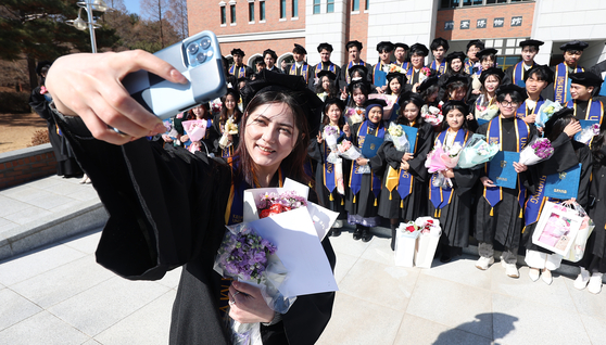 International students of Keimyung University take a group photo at its international student-only ceremony on Feb.18. [YONHAP]