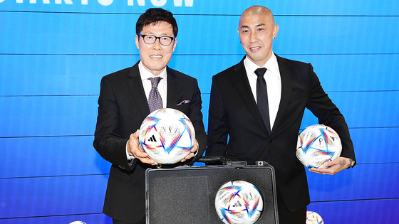 Cha Bum-kun, left, poses with Cha Du-ri during a Qatar World Cup official ball exhibition event at the Adidas Hongdae Brand Center in western Seoul on April 28, 2022. [ADIDAS] 
