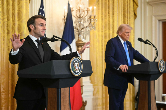 U.S. President Donald Trump and French President Emmanuel Macron hold a joint press conference in the East Room to the White House in Washington, D.C., on Feb. 24. [AFP/YONHAP]