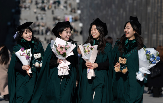 Students of Ewha Womans University pose for a photo after their graduation ceremony on Monday. [NEWS1]