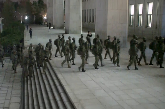 Martial law troops are seen moving into the National Assembly building during President Yoon Suk Yeol's short declaration of emergency martial law on Dec. 3, 2024. [YONHAP] 