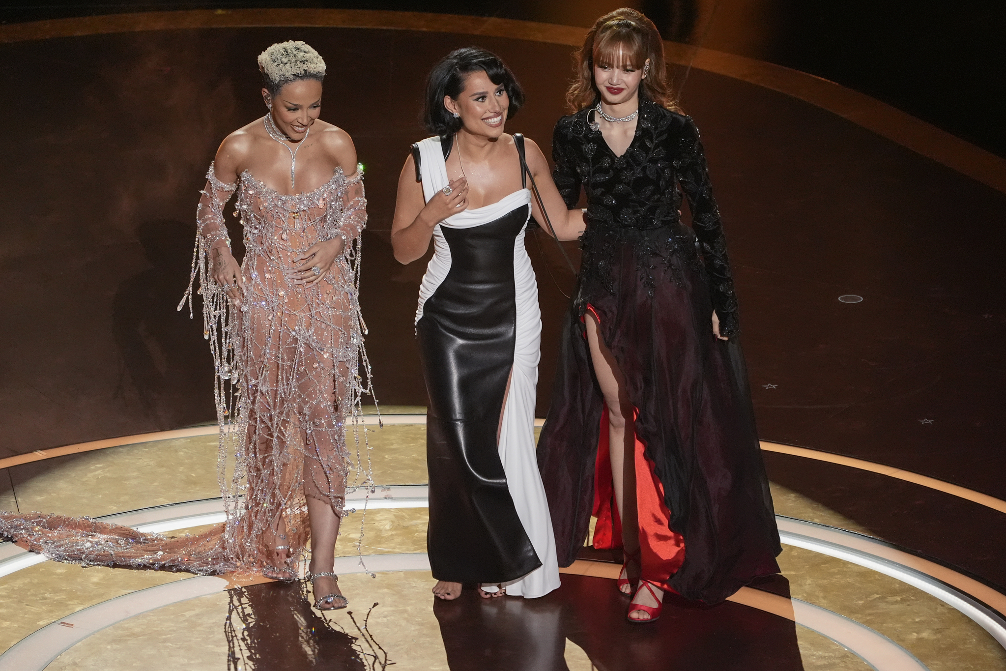 From left are Doja Cat, Raye, and Lisa on stage during the Oscars on March 2, at the Dolby Theatre in Los Angeles. [AP/YONHAP] 