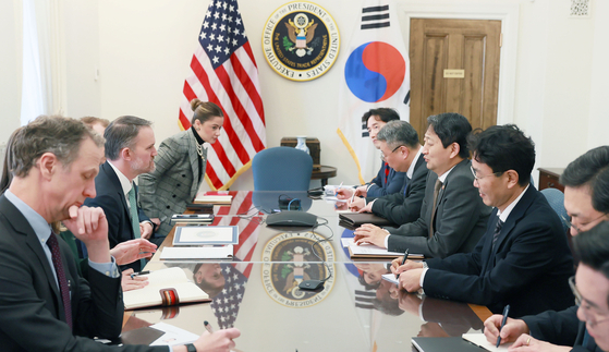 Minister of Trade, Industry and Energy Ahn Duk-geun, center in the right row, speaks with U.S. Trade Representative Jamieson Greer in a conference room of the United States Trade Representative in Washington on March 1. [YONHAP]