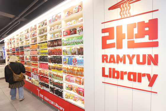 A person browses a selection of ramyeon at the Ramyun Library in a convenience store near Hongik University in Mapo District, western Seoul, on March 6. [YONHAP]