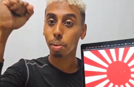 Johnny Somali, whose legal name is Ramsey Khalid Ismael, streams with the Japanese Rising Sun Flag displayed on his laptop on Oct. 30, 2024. [SCREEN CAPTURE]