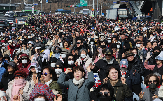 Supporters of President Yoon Suk Yeol take part in a rally led by conservative activist pastor Jeon Kwang-hoon near the presidential residence in Hannam-dong, Yongsan District, central Seoul on March 9. [NEWS1]