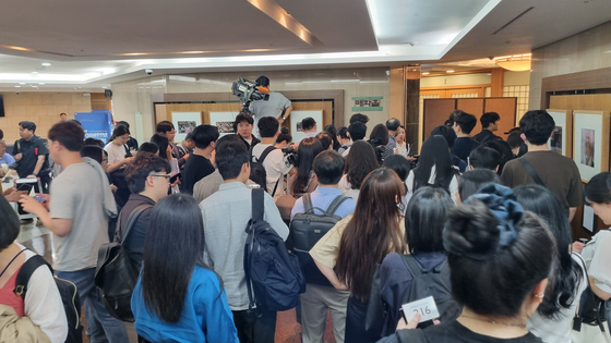 Reporters wait outside the Korea Press Center in Jung District, central Seoul on Friday afternoon. [YOON SO-YEON]