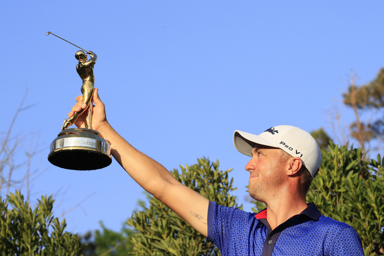Justin Thomas celebrates with the trophy after winning during the final round of The Players Championship on The Players Stadium Course at TPC Sawgrass on March 14, 2021 in Ponte Vedra Beach, Florida. [GETTY IMAGES]