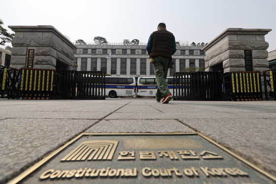 A person walks into the Constitutional Court in Jongno District, central Seoul, on March 7. [YONHAP]