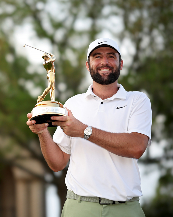 Scottie Scheffler poses with the trophy after winning The Players Championship at TPC Sawgrass on March 17, 2024 in Ponte Vedra Beach, Florida. [GETTY IMAGES]