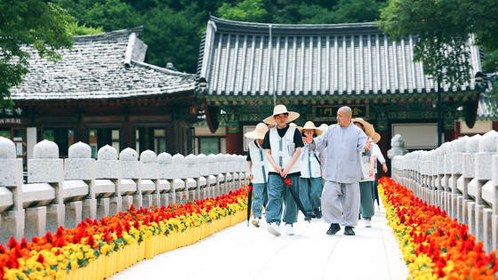 Participants stroll inside Baekdam Temple located in Inje County in Gangwon during a temple stay program held on June 11, 2023. From March to May, over 100 Buddhist temples will be hosting temple stay programs at discount prices as part of the government's spring travel campaign.  [INJE COUNTY] 