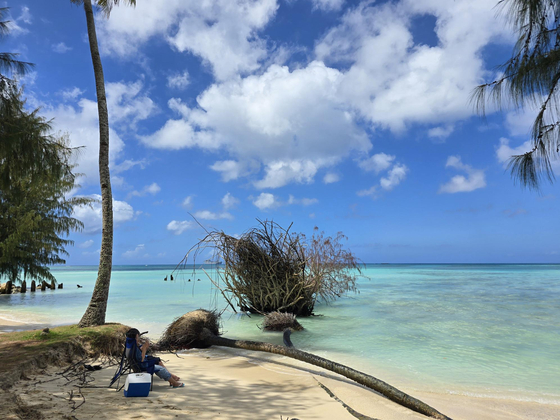 Tourists look out to the sea at the Micro Beach in Saipan. [CORAL OCEAN RESORT SAIPAN]