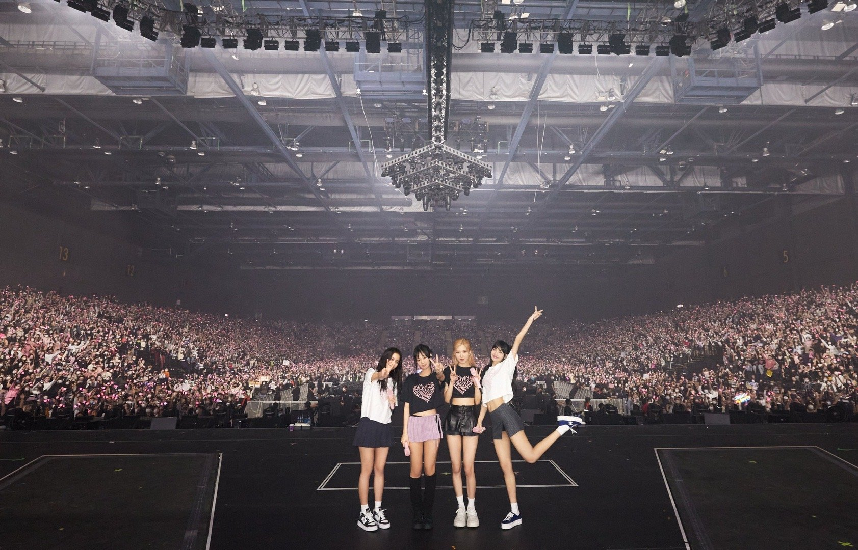 K-pop group Blackpink members pose for a commemorative photo with the audience in the background, during the group's concert in Hong Kong, in January 2023. [BLACKPINK WEIBO]