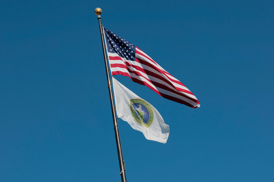 United States and U.S. Department of Energy flags fly near the department's headquarters on Feb. 14 in Washington. [AFP/YONHAP]