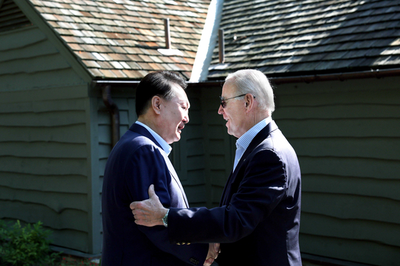 South Korean President Yoon Suk Yeol, left, and former U.S. President Joe Biden greet eachother at the Camp David presidential retreat in Maryland on Aug. 18, 2023. [PRESIDENTIAL OFFICE]