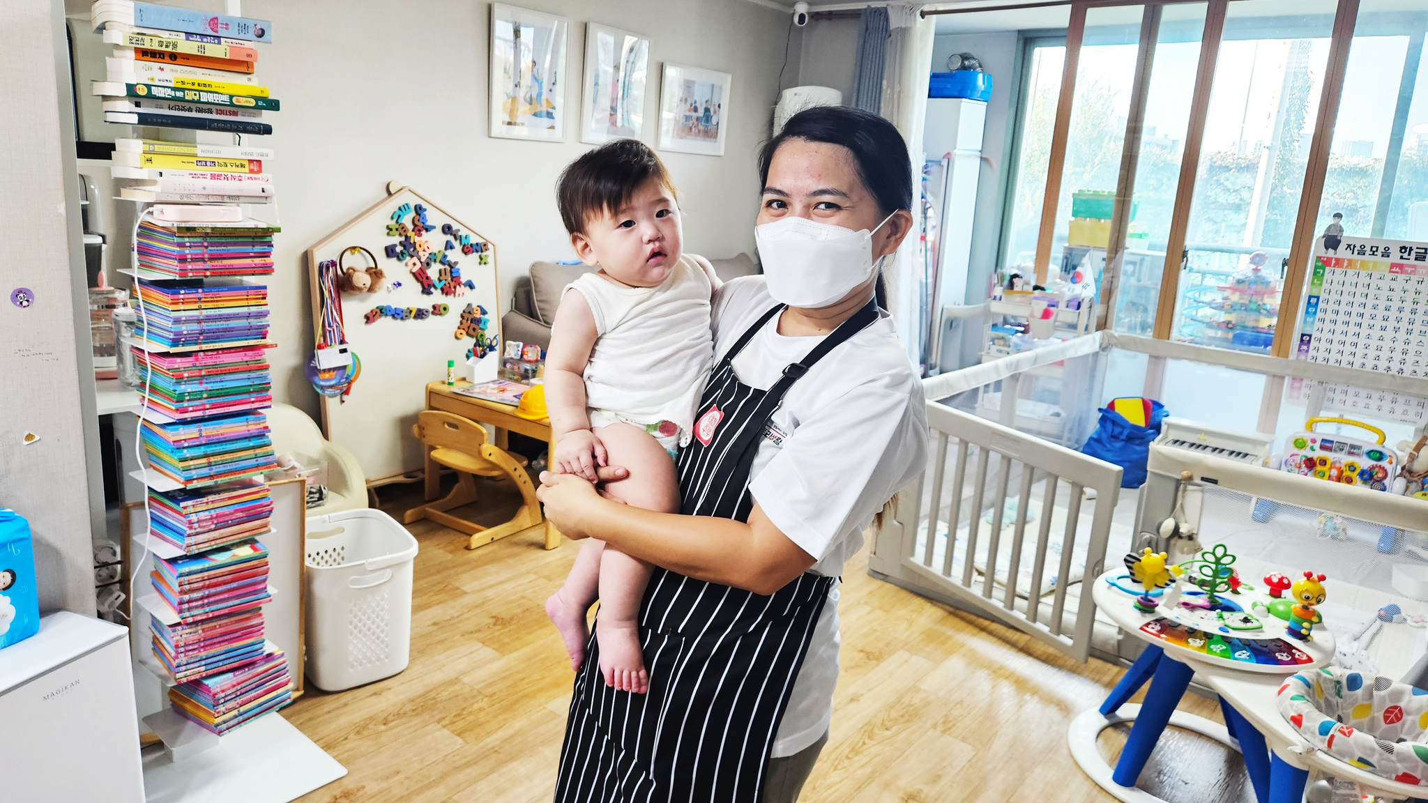 A Filipino caregiver holds a baby at a household in Seoul on Sept. 3, 2024. [SEOUL METROPOLITAN GOVERNMENT]