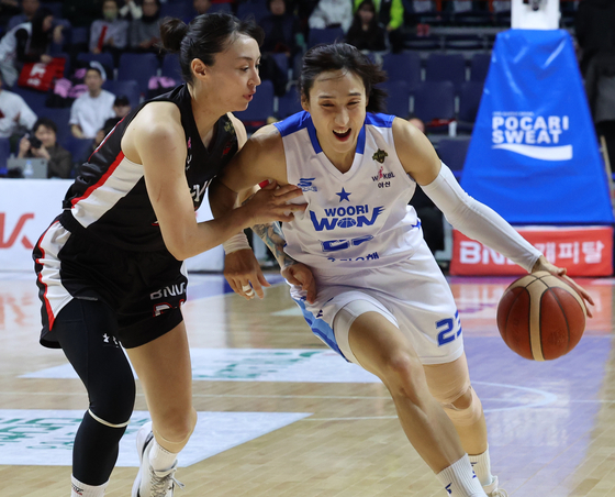 Asan Woori Bank Woori Won small forward Kim Dan-bi, right, dribbles during a WKBL playoff game against Busan BNK Sum at Sajik Gymnasium in Busan on March 20. [YONHAP] 