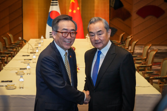 Foreign Minister Cho Tae-yul, left, poses with Chinese Foreign Minister Wang Yi during their talks in Tokyo on March 21, held a day before the planned trilateral meeting involving their Japanese counterpart, Takeshi Iwaya. Cho told Wang that Korea’s legitimate and lawful maritime rights "must not be undermined by China’s activities in the Yellow Sea," while Wang called for continued dialogue based on mutual respect, according to the Korean Foreign Ministry. [MINISTRY OF FOREIGN AFFAIRS]
