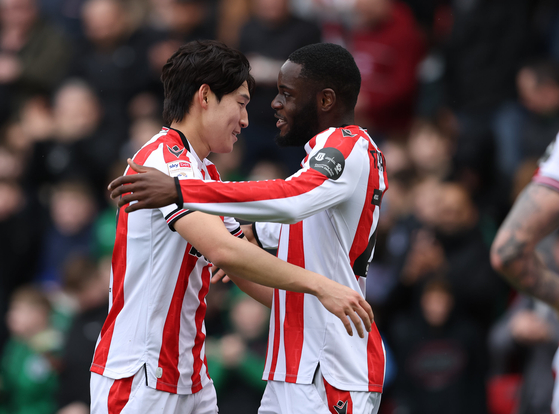 Stoke City midfielder Bae Jun-ho, left, celebrates during a Championship match against QPR at bet365 Stadium in Stoke-on-Trent, England, in a photo shared on Stoke's X account on March 29. [SCREEN CAPTURE]