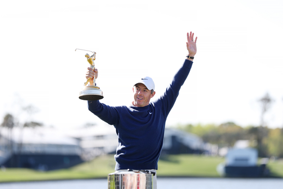 Rory McIlroy celebrates with the trophy after winning the playoff in the final round of The Players Championship on the Stadium Course at TPC Sawgrass on March 17 in Ponte Vedra Beach, Florida. [GETTY IMAGES] 