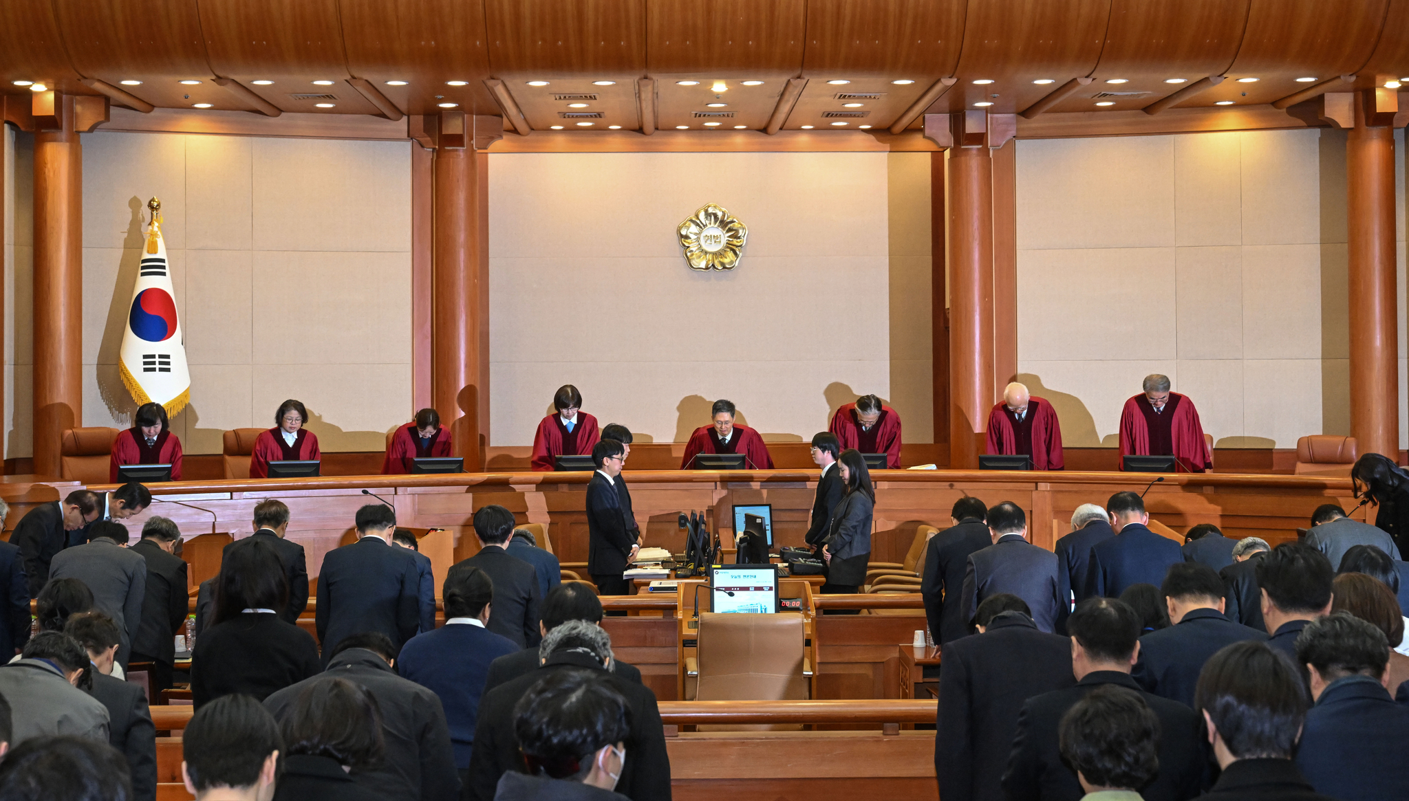The eight justices of the Constitutional Court bow before taking their seats at the 11th and final hearing of President Yoon Suk Yeol's impeachment trial in Jongno District, central Seoul, on Feb. 25. [JOINT PRESS CORPS]