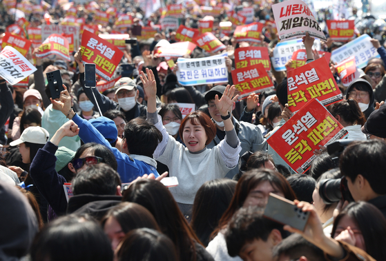 People near President Yoon's presidenital residence in Yongsan District, central Seoul, cry in joy after the Constitutional Court ruled to uphold Yoon's impeachment. [YONHAP]
