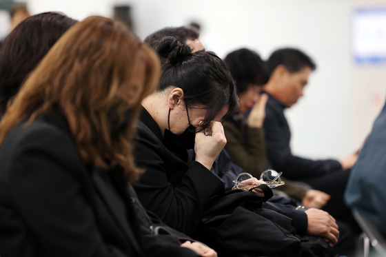 Families of the victims of the Jeju Air crash weep at a memorial hall set up at the Muan Airport South Jeolla on April 5. [YONHAP]