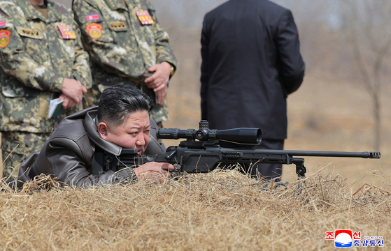North Korean leader Kim Jong-un personally test-fires a newly developed sniper rifle during a visit to the country's special forces on April 4, the day when South Korea’s Constitutional Court delivered its ruling to uphold Yoon's impeachment. [YONHAP]